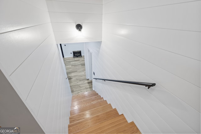 stairs featuring wood-type flooring