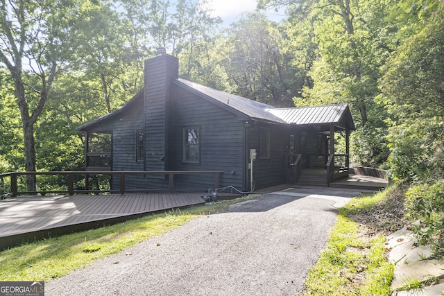 view of property exterior featuring a wooden deck