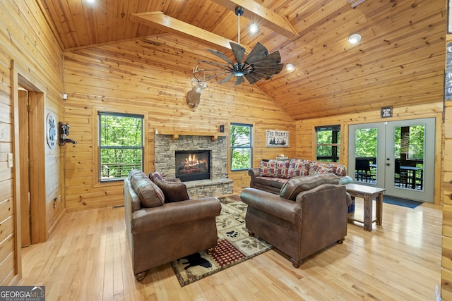 living room with wooden ceiling, light wood-type flooring, beam ceiling, and wooden walls