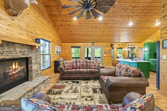 living room with wooden ceiling, wooden walls, french doors, light hardwood / wood-style flooring, and vaulted ceiling