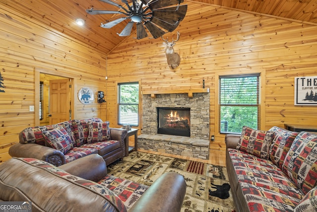 living room with a wealth of natural light, wooden walls, wooden ceiling, and high vaulted ceiling