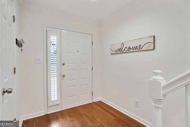 entryway with hardwood / wood-style floors, crown molding, and a healthy amount of sunlight