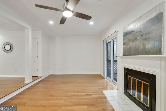 unfurnished living room with a fireplace, light hardwood / wood-style flooring, ceiling fan, and crown molding