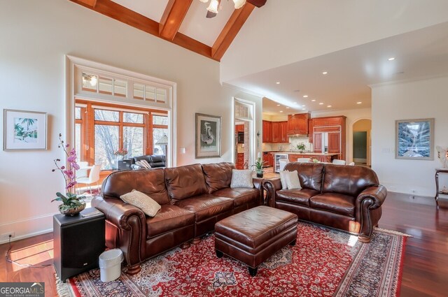 living room featuring hardwood / wood-style floors, beamed ceiling, and high vaulted ceiling