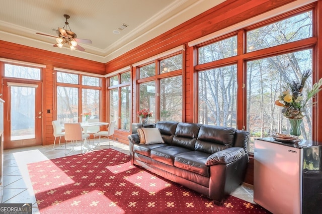 sunroom / solarium featuring ceiling fan