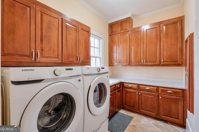 laundry area featuring washer and clothes dryer, ornamental molding, light tile patterned floors, and cabinets