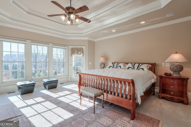 bedroom featuring ceiling fan, crown molding, and a tray ceiling