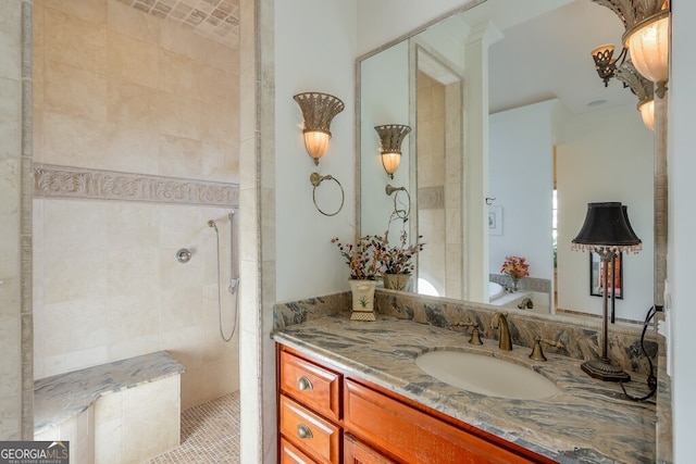 bathroom with vanity, ornamental molding, and a tile shower