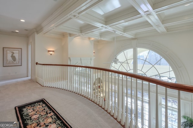 hallway with ornamental molding, coffered ceiling, carpet, and beam ceiling