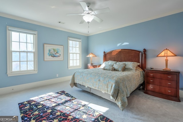 carpeted bedroom featuring ceiling fan and ornamental molding