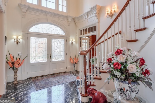 foyer entrance featuring a high ceiling and french doors