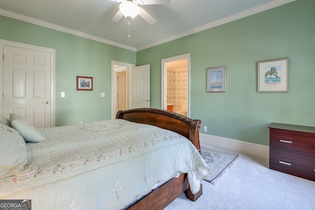 carpeted bedroom with ceiling fan, ornamental molding, and ensuite bath