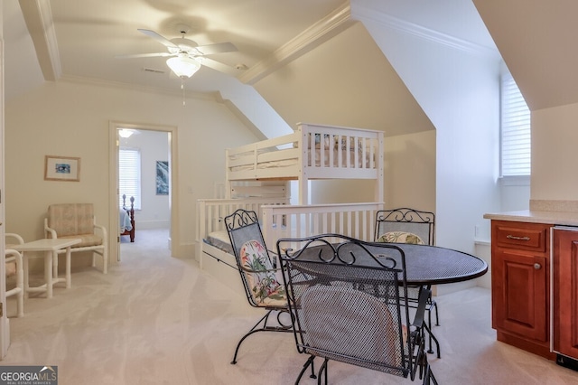 dining area featuring light colored carpet, ceiling fan, and ornamental molding