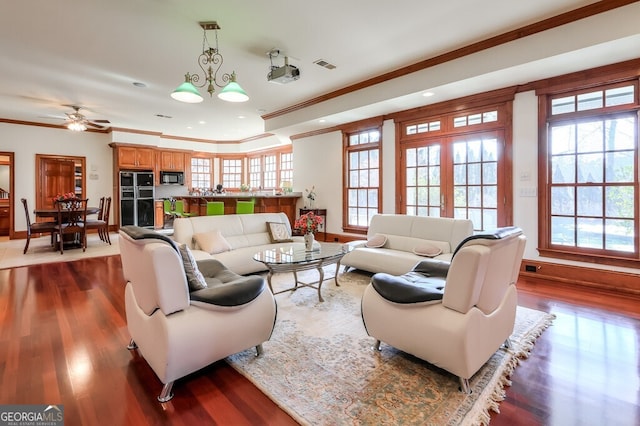 living room with french doors, dark hardwood / wood-style flooring, crown molding, and a notable chandelier