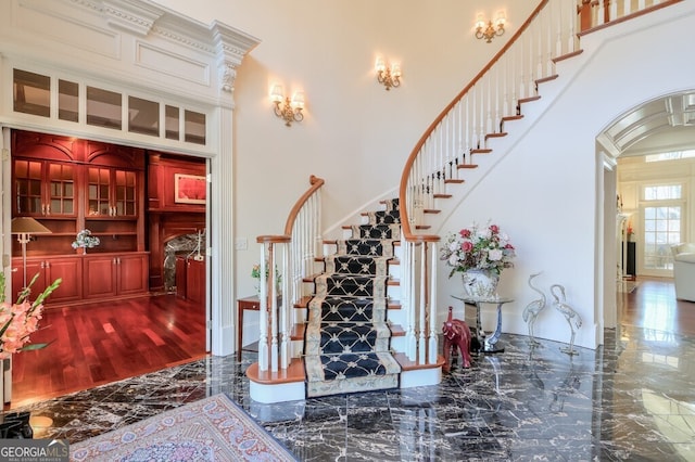 staircase featuring a high ceiling