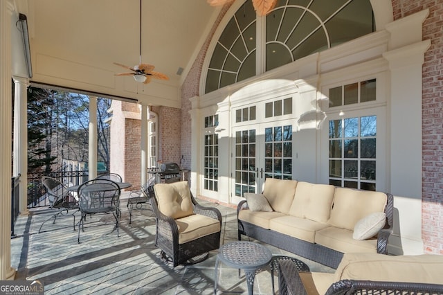 sunroom / solarium with ceiling fan and french doors