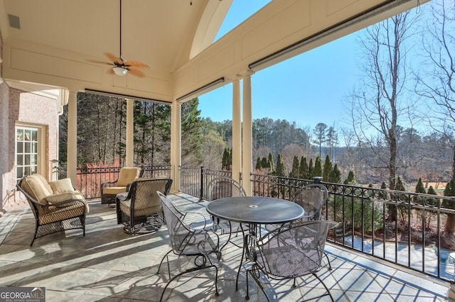 sunroom / solarium with vaulted ceiling and ceiling fan