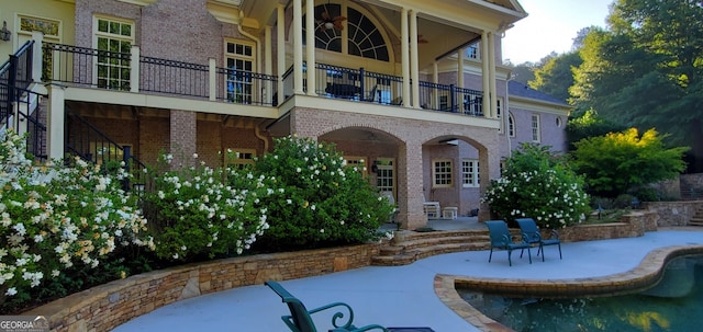 back of house with a patio area and a balcony