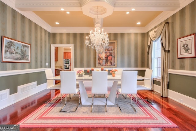 dining space with a chandelier, ornamental molding, and wood-type flooring