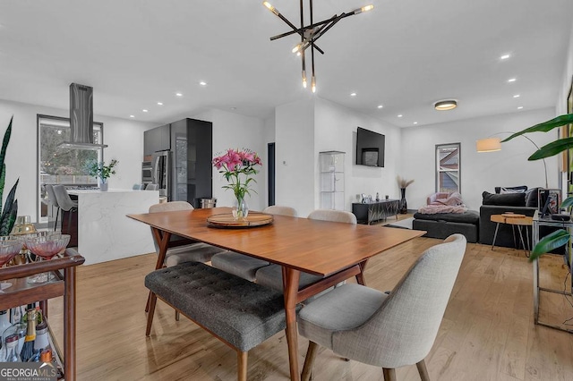 dining room with a notable chandelier and light hardwood / wood-style floors