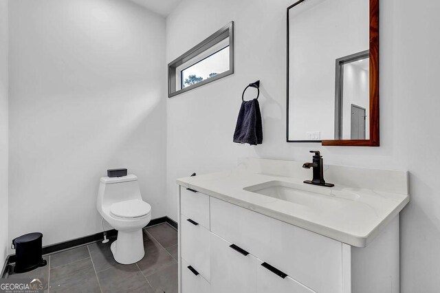 bathroom featuring tile patterned floors, vanity, and toilet