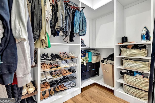 spacious closet featuring hardwood / wood-style floors