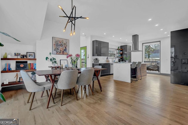 dining area featuring a notable chandelier and light wood-type flooring