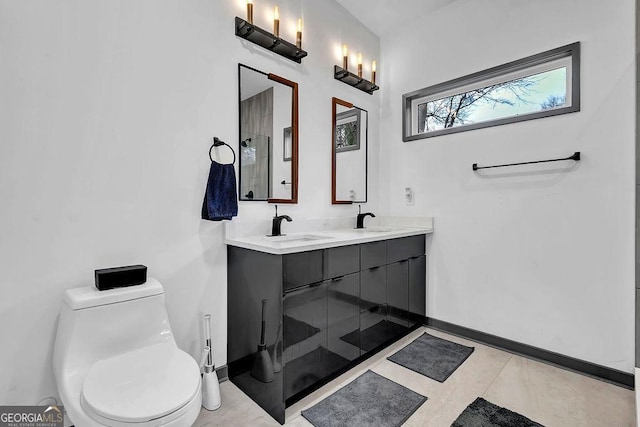 bathroom featuring vanity, tile patterned flooring, and toilet