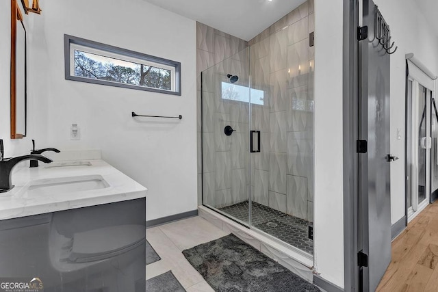 bathroom with an enclosed shower and vanity