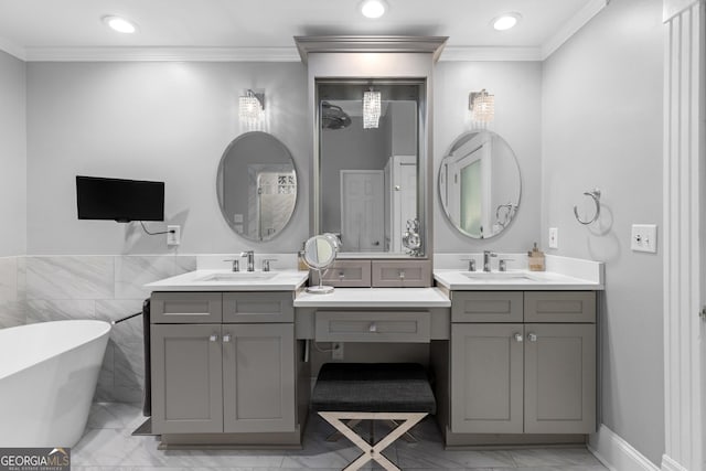 bathroom with a tub, tile walls, vanity, and crown molding