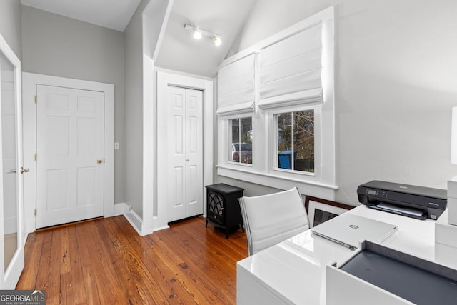 home office with hardwood / wood-style floors and vaulted ceiling