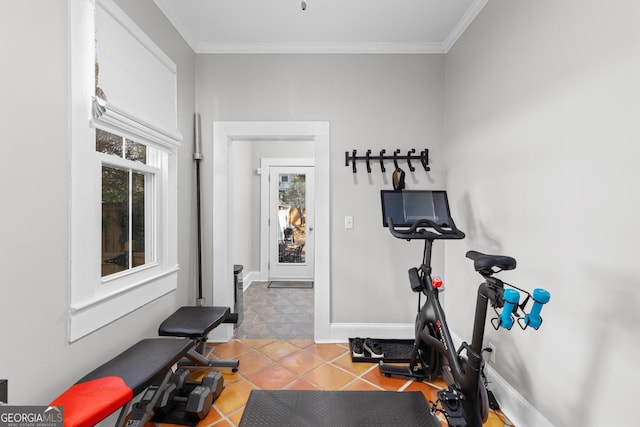 workout room featuring crown molding