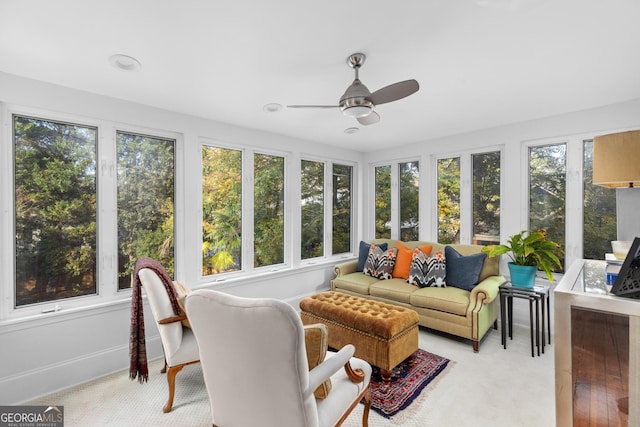 sunroom / solarium with a healthy amount of sunlight and ceiling fan