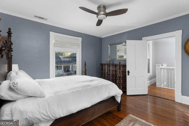 bedroom featuring dark hardwood / wood-style floors, ceiling fan, and ornamental molding