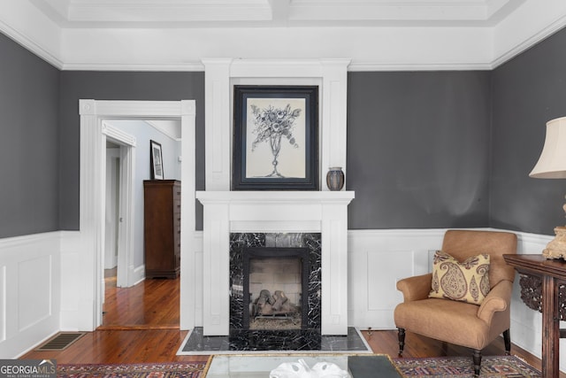 living room with a high end fireplace and dark hardwood / wood-style floors