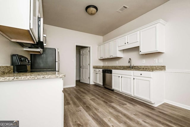 kitchen featuring light stone countertops, stainless steel dishwasher, white cabinets, sink, and dark wood-type flooring