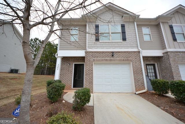 multi unit property featuring central AC unit and a garage