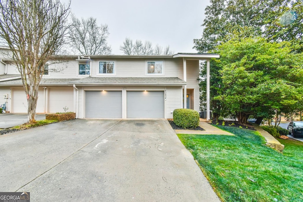 front of property featuring a garage and a front yard