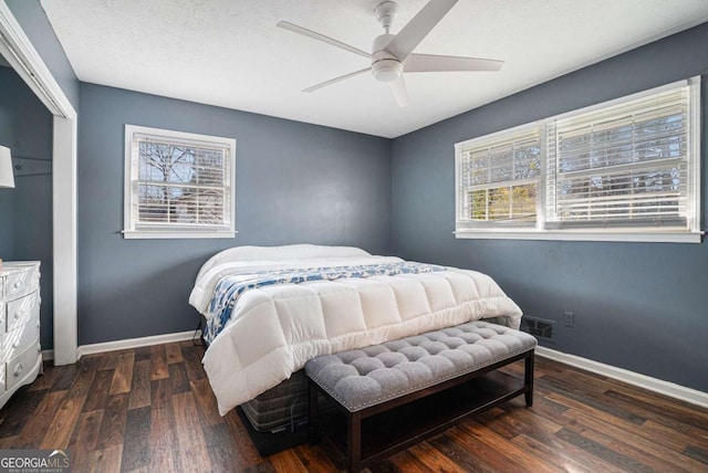 bedroom with ceiling fan, a closet, a textured ceiling, and dark hardwood / wood-style flooring