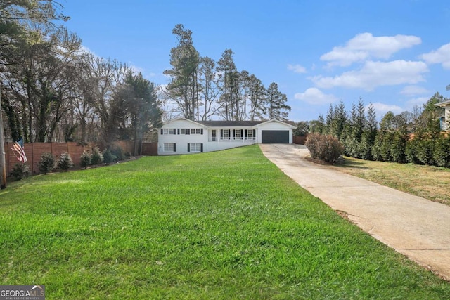 single story home featuring a garage and a front lawn