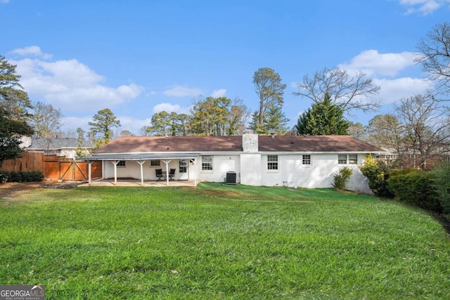 back of property featuring central air condition unit, a patio, and a lawn