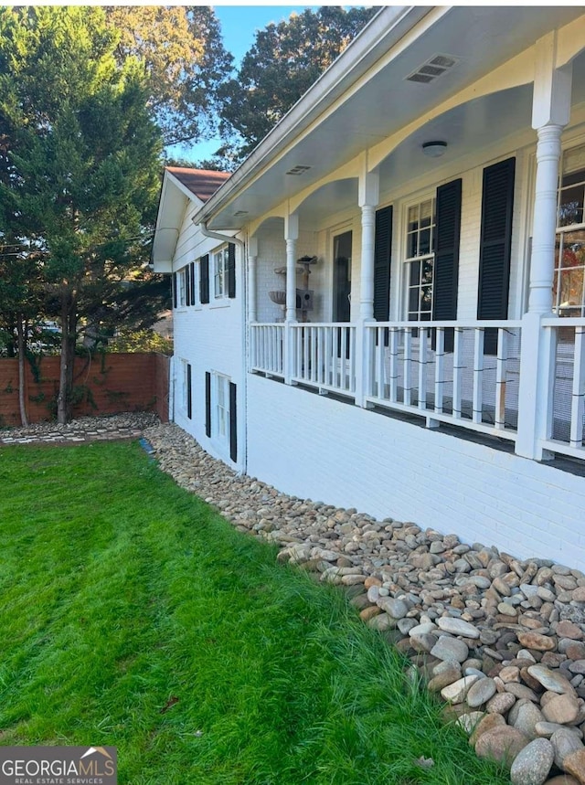 view of side of property with a yard