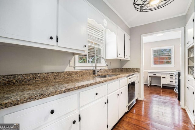 kitchen with sink, white cabinetry, dark stone countertops, dark hardwood / wood-style flooring, and dishwasher