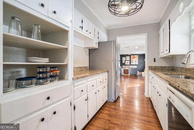 kitchen featuring dishwasher, sink, dark stone countertops, and white cabinets