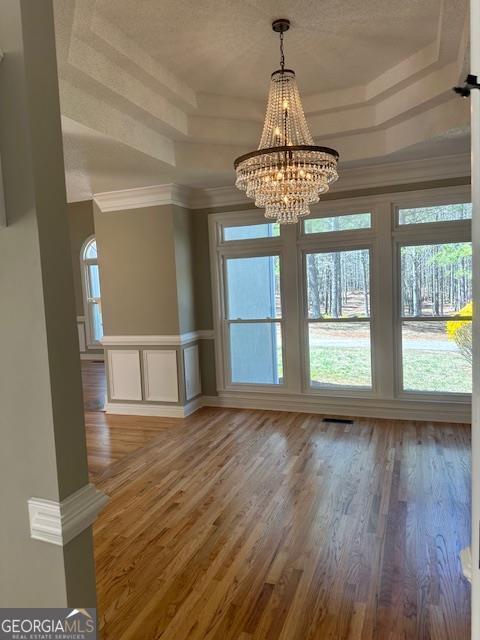 kitchen featuring double oven, decorative light fixtures, and white cabinets