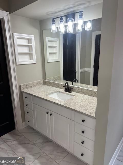 bathroom with vanity and built in shelves