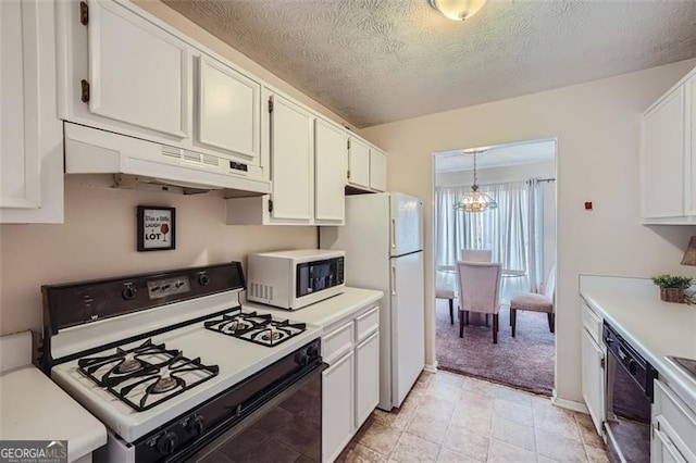 kitchen featuring a textured ceiling, white appliances, white cabinetry, and pendant lighting