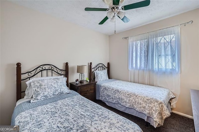 carpeted bedroom featuring ceiling fan and a textured ceiling