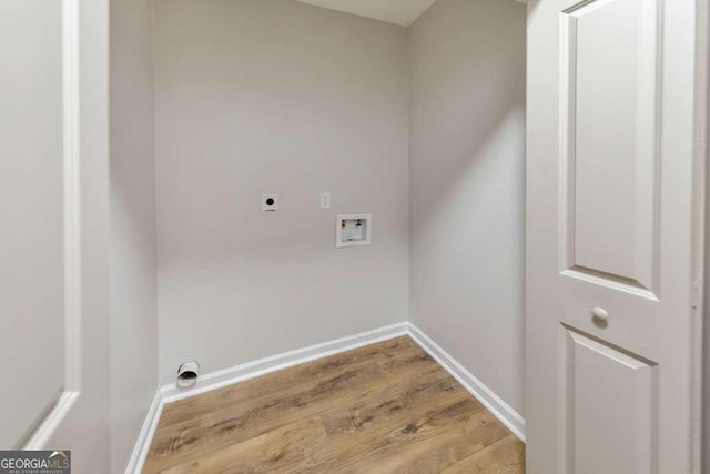 clothes washing area with hookup for a washing machine, electric dryer hookup, and light wood-type flooring