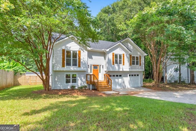 raised ranch with a garage and a front yard